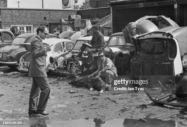 French-Swiss film director, screenwriter, and film critic Jean-Luc Godard directing a scene with actors on the set of film 'One Plus One' , his first...