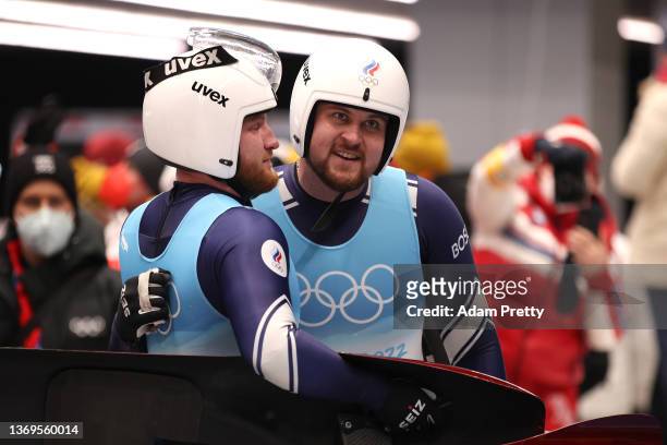 Aleksandr Denisyev and Vladislav Antonov of Team ROC react after sliding during the Luge Doubles Run 2 on day five of the Beijing 2022 Winter Olympic...