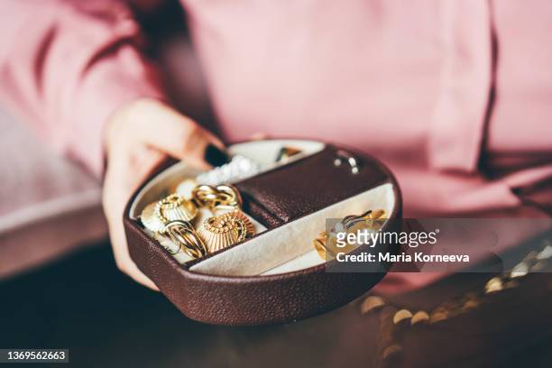 woman chooses jewelry at home. - jewellery display stock pictures, royalty-free photos & images