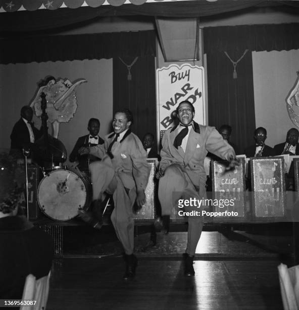 Two dancers, dressed in Zoot suits, perform on stage in front of a band at Club Bali, a jazz club and night club on 14th Street in Washington DC,...