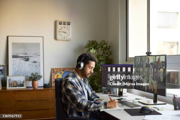 businesswoman writing in diary at home office - escritório pequeno imagens e fotografias de stock