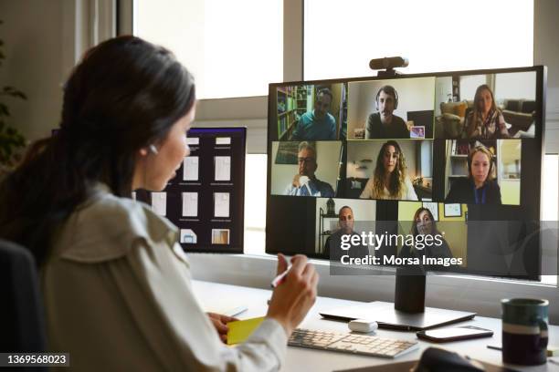 businesswoman planning strategy on video call - working at home desktop computer stock-fotos und bilder