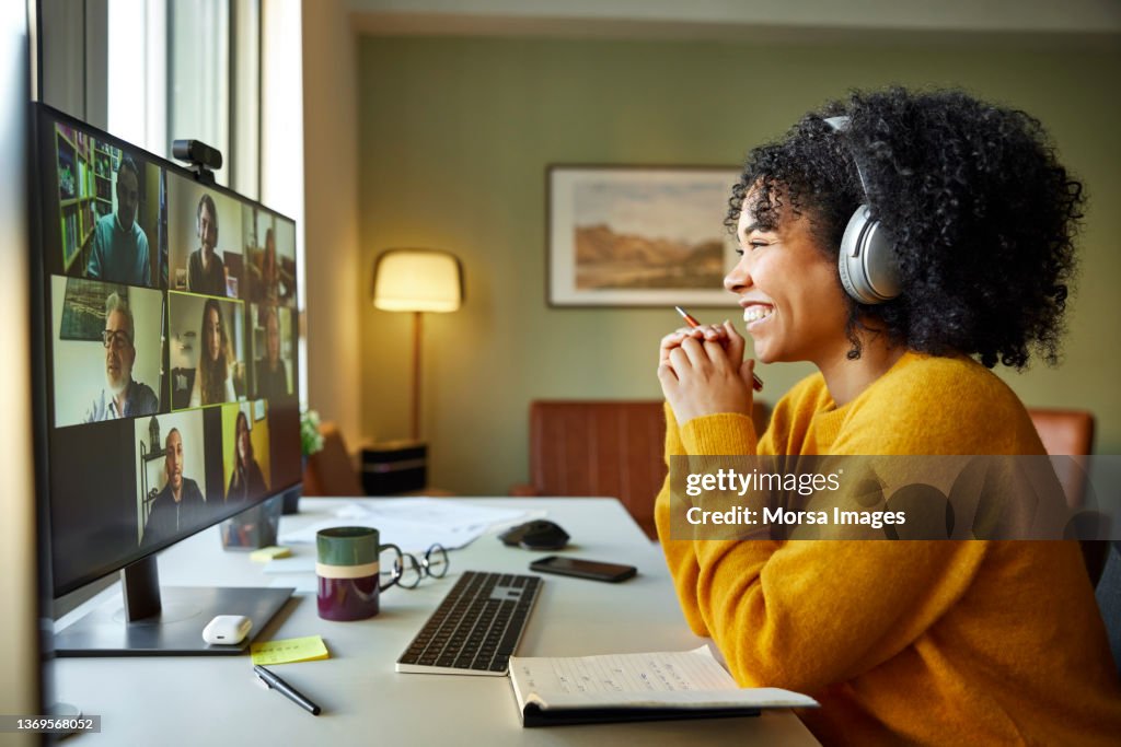 Multiracial colleagues discussing on video call