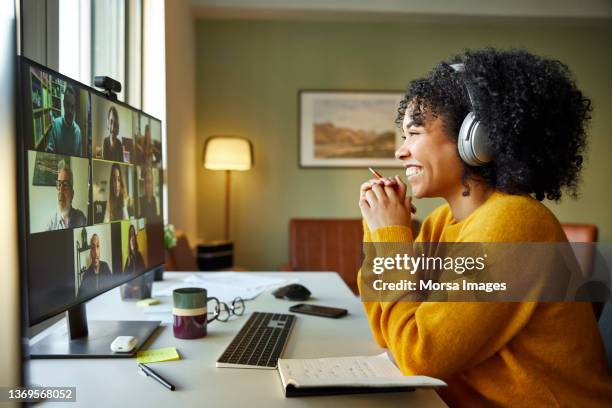 multiracial colleagues discussing on video call - coworker imagens e fotografias de stock