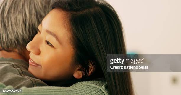 shot of a daughter hugging her father at home - old man young woman stock pictures, royalty-free photos & images