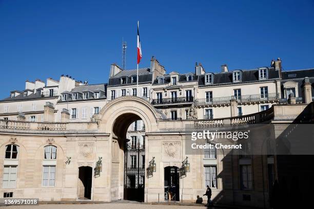French flag flutters in the sky atop the entrance to the Elysee presidential palace during the weekly cabinet meeting on February 09, 2022 in Paris,...