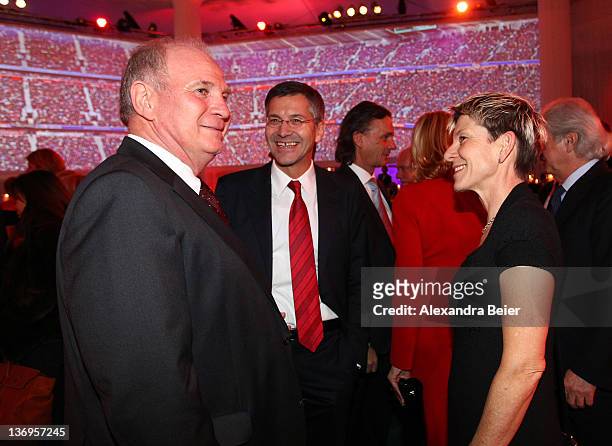 Uli Hoeness talks to Herbert Hainer and Angelika Hainer at the Uli Hoeness' 60th birthday celebration at Postpalast on January 13, 2012 in Munich,...