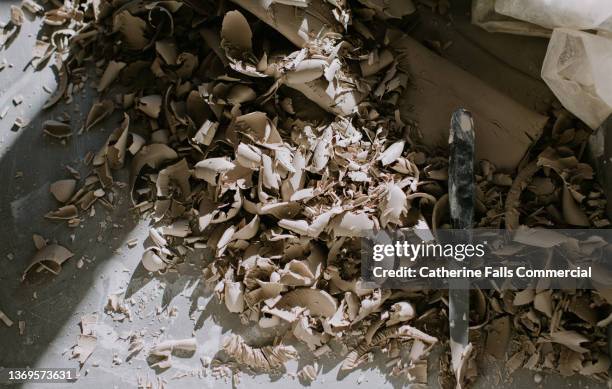 clay shavings lie on a shadowy table - shavings stock pictures, royalty-free photos & images