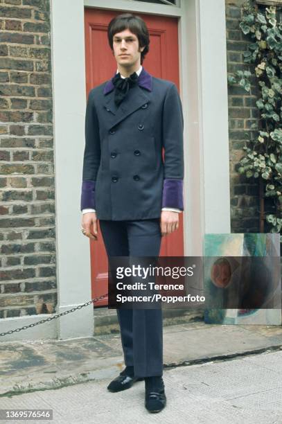 Young "Mod" dressed in a smart tailored suit, the jacket is double breasted and features contrasting purple velvet cuffs and lapels, London circa...