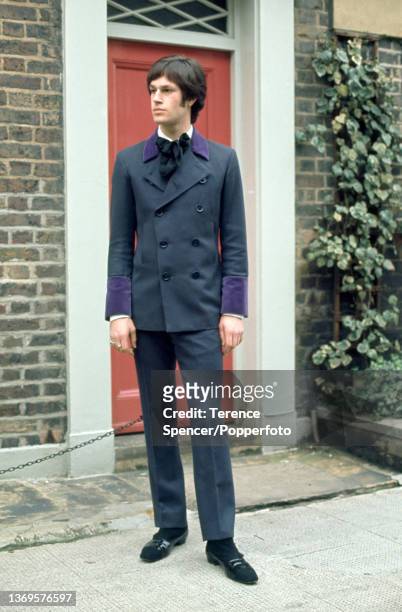Young "Mod" dressed in a smart tailored suit, the jacket is double breasted and features contrasting purple velvet cuffs and lapels, London circa...