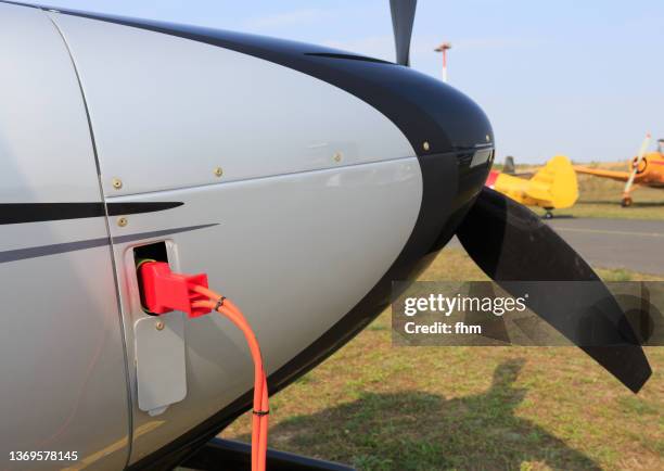 charging plug at an electric propeller aircraft - aerospace stockfoto's en -beelden