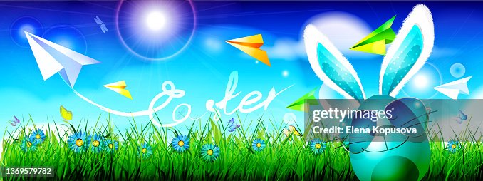 Happy Easter! Anthropomorphic easter egg with bunny ears on a bright spring sky background with bokeh effect. Happy Easter! Anthropomorphic easter egg with bunny ears on a bright spring sky background with bokeh effect.