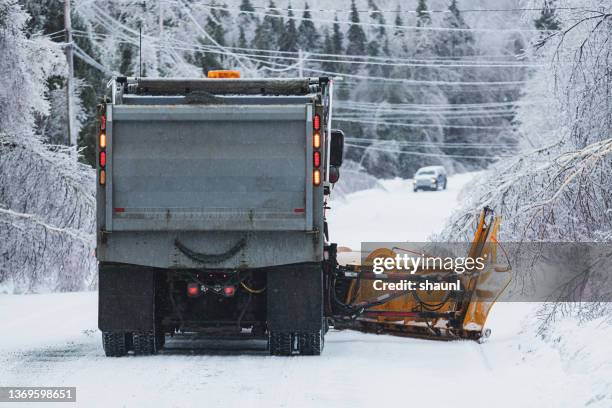 snowplow clears road during ice storm - snow plow truck stock pictures, royalty-free photos & images