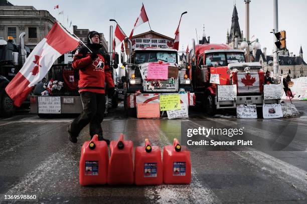 Hundreds of truck drivers and their supporters block the streets of downtown Ottawa as part of a convoy of protesters against COVID-19 mandates in...