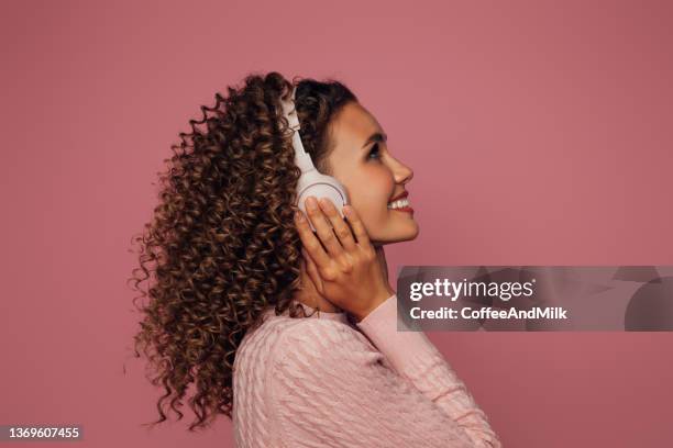 beautiful emotional woman listening to music - personal stereo stock pictures, royalty-free photos & images