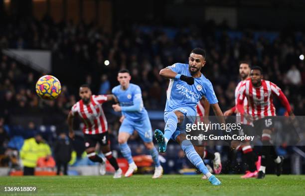 Riyad Mahrez of Manchester City scores their side's first goal from the penalty spot during the Premier League match between Manchester City and...
