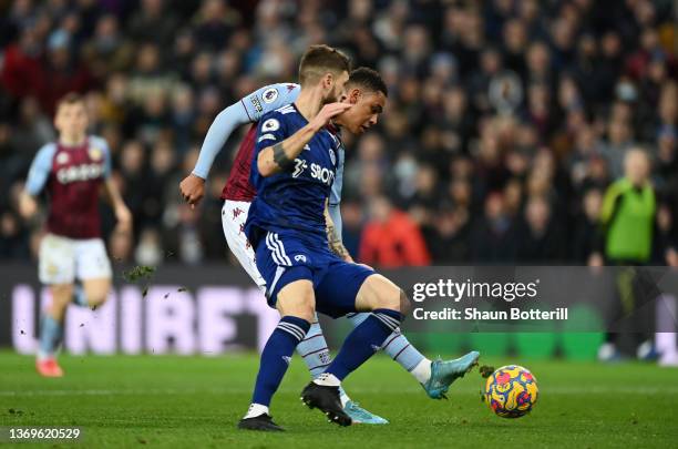 Jacob Ramsey of Aston Villa scores their side's second goal whilst under pressure from Mateusz Klich of Leeds United during the Premier League match...