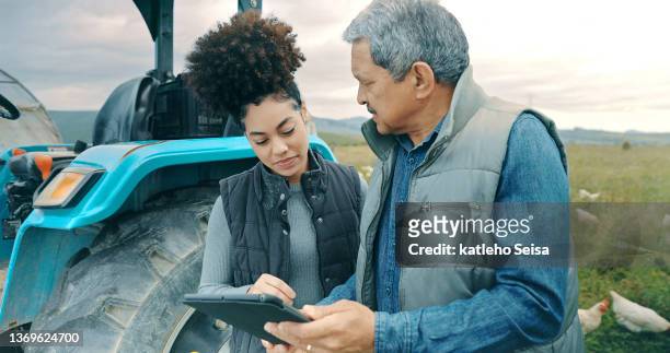 shot of a man and woman using a digital tablet while working together on a poultry farm - agricultural equipment stockfoto's en -beelden