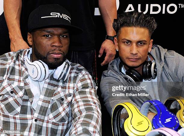 Rapper and SMS Audio CEO 50 Cent and television personality DJ Paul "Pauly D" DelVecchio pose during an autograph session at the SMS Audio booth at...