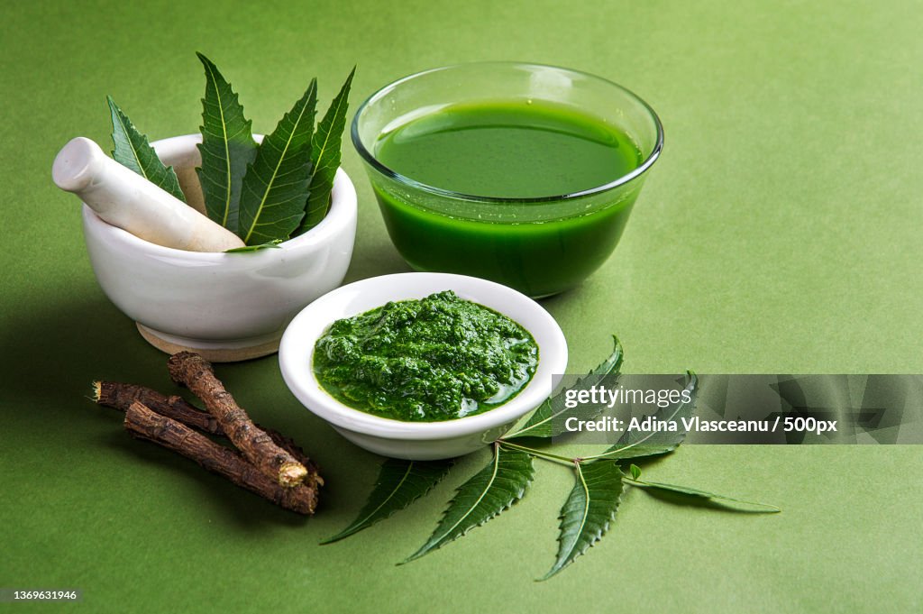 Medicinal Neem leaves in mortar and pestle with neem paste