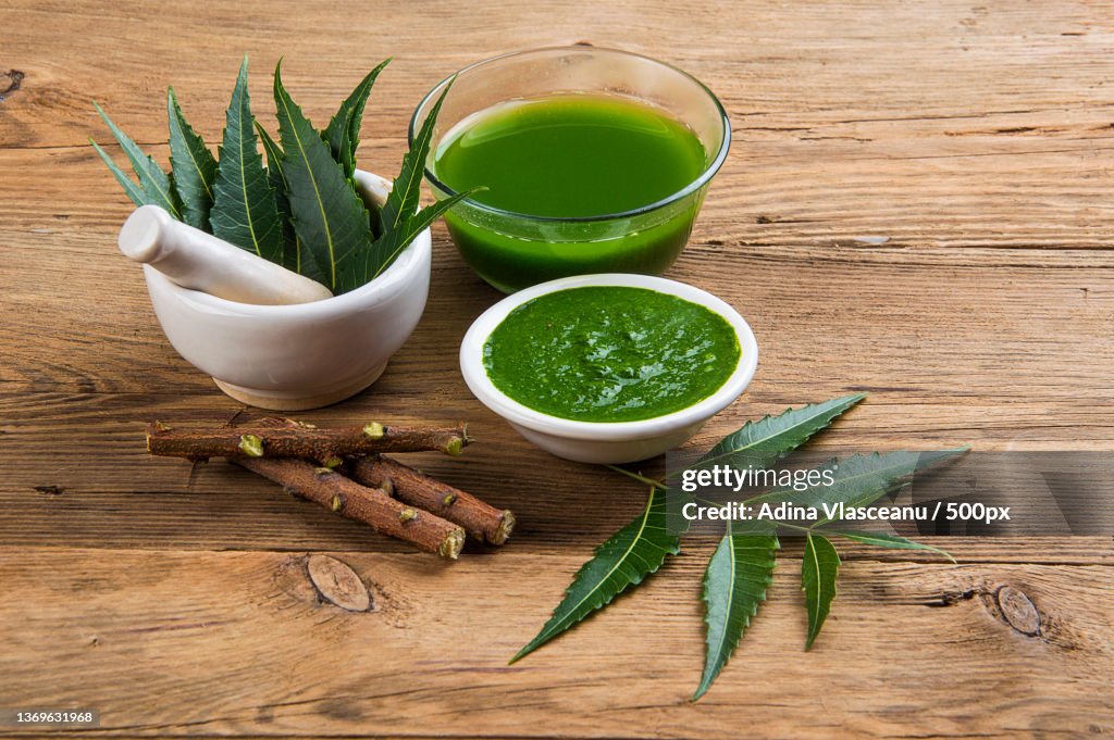 Medicinal Neem leaves in mortar and pestle with neem paste