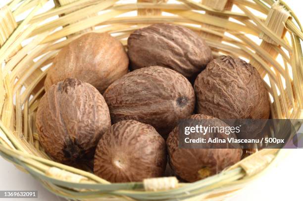 nutmeg in bamboo basket isolated on white background - malabarica stock pictures, royalty-free photos & images