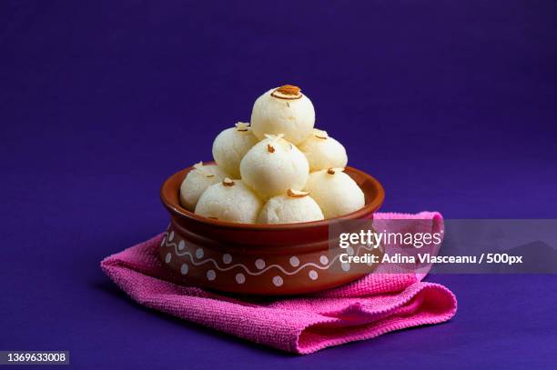 indian sweet or dessert,close-up of sweet food in plate on table against purple background - mithai stock pictures, royalty-free photos & images