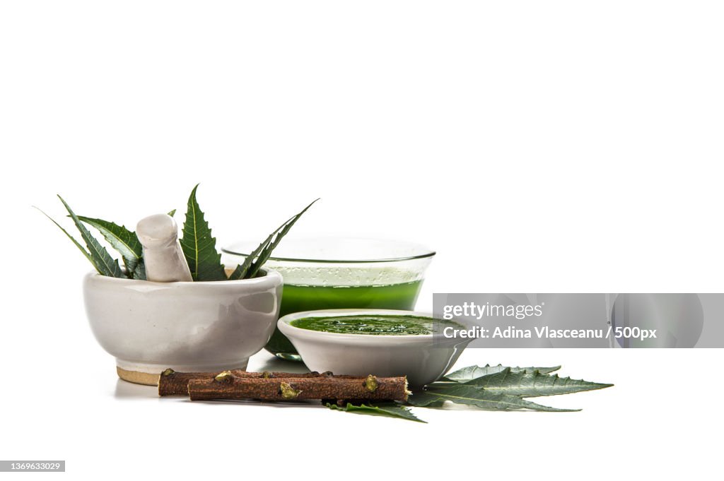 Medicinal Neem leaves in mortar and pestle with neem paste