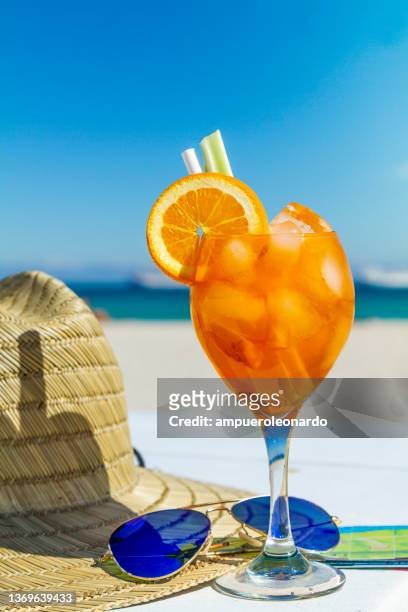 juicy refreshing alcoholic cocktail served in a sunny day in front of atlantic ocean near to ocean drive at the most famous beach in south beach, miami beach, miami, south florida, united states of america. - tequila sunrise stockfoto's en -beelden