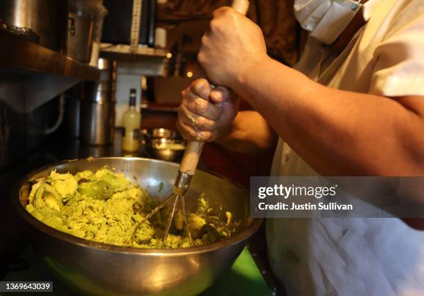 Jorge Granada prepares guacamole at Tommy's Mexican Restaurant on February 09, 2022 in San Francisco, California. A week ahead of Super Bowl Sunday,...