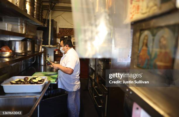 Jorge Granada prepares guacamole at Tommy's Mexican Restaurant on February 09, 2022 in San Francisco, California. A week ahead of Super Bowl Sunday,...