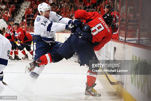 Alex Ovechkin of the Washington Capitals and Brett Connolly of the Tampa Bay Lightning fight for the puck during an NHL hockey game on January 13,...
