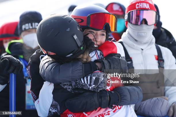 Chloe Kim of Team United States embraces Ailing Eileen Gu of Team China during the Women's Snowboard Halfpipe Final on Day 6 of the Beijing 2022...