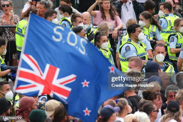 Police officers look on during a protest at Parliament on February 10, 2022 in Wellington, New Zealand. Anti-vaccine and Covid-19 mandate protesters...