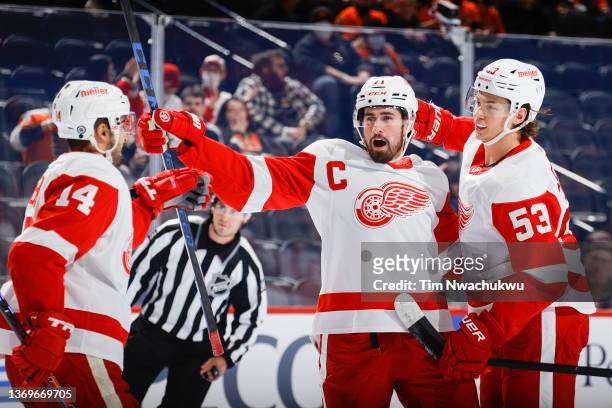 Dylan Larkin of the Detroit Red Wings celebrates after scoring with teammates Robby Fabbri and Moritz Seider during the first period against the...