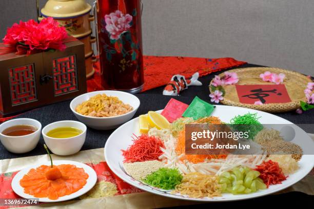 chinese new year traditional dishes raw fish lau sang yee sang - chinese new year food stock pictures, royalty-free photos & images