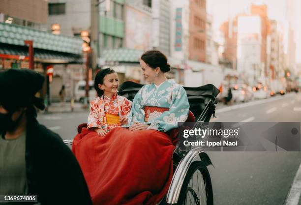 young girl and her mother in kimono on rickshaw ride, tokyo, japan - foreign cultures stock pictures, royalty-free photos & images