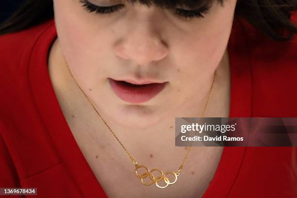 Detail of the Olympic rings' necklace of Halley Duff of Team Great Britain is seen as she curls the stone against Team Japan during the Women's Round...
