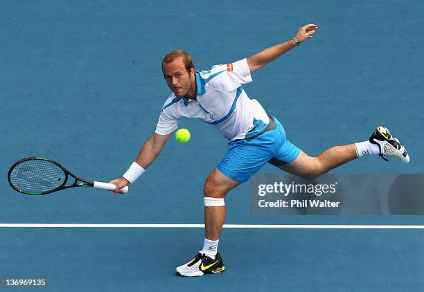 Olivier Rochus of Belguim plays a shot in his match against David Ferrer of Spain during day six of the 2012 Heineken Open at ASB Tennis Centre on...