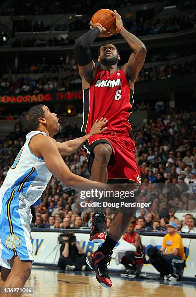 LeBron James of the Miami Heat takes a shot over Andre Miller of the Denver Nuggets at the Pepsi Center on January 13, 2012 in Denver, Colorado. NOTE...