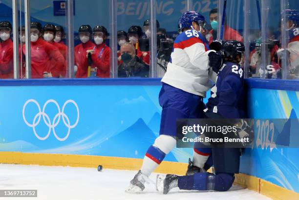 Hannes Bjorninen of Team Finland is checked by Marko Dano of Team Slovakia into the boards in the first period during the Men's Ice Hockey...