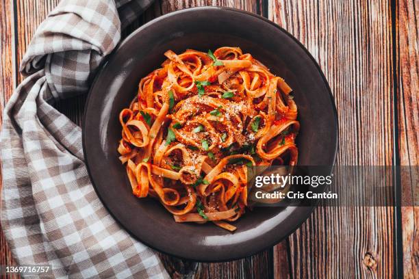 tagliatelle with tomato sauce on wooden background. - pasta fotografías e imágenes de stock
