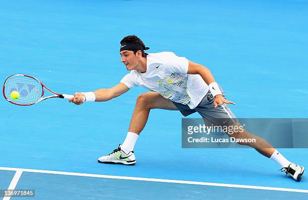Bernard Tomic of Australia plays a forehand during his match against Mardy Fish of the United States during day four of the 2012 Kooyong Classic at...