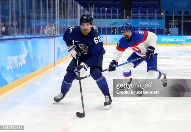Markus Granlund of Team Finland challenges Simon Nemec of Team Slovakia in the second period during the Men's Ice Hockey Preliminary Round Group C...