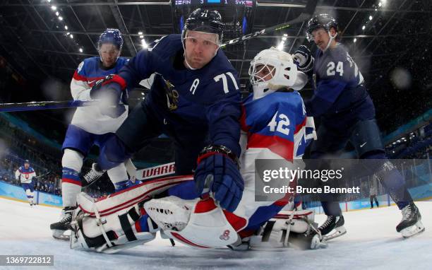 Leo Komarov of Team Finland collides with Branislav Konrad, goaltender of Team Slovakia in the second period during the Men's Ice Hockey Preliminary...