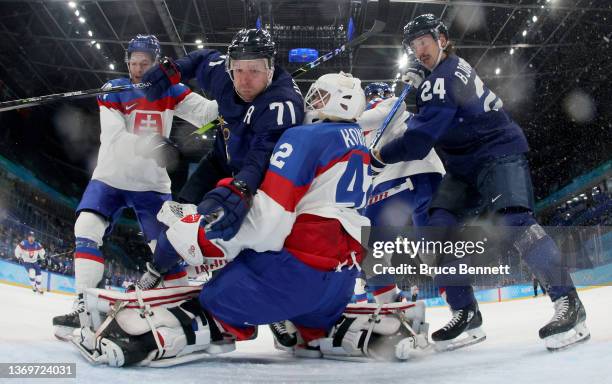 Leo Komarov of Team Finland collides with Branislav Konrad, goaltender of Team Slovakia in the second period during the Men's Ice Hockey Preliminary...