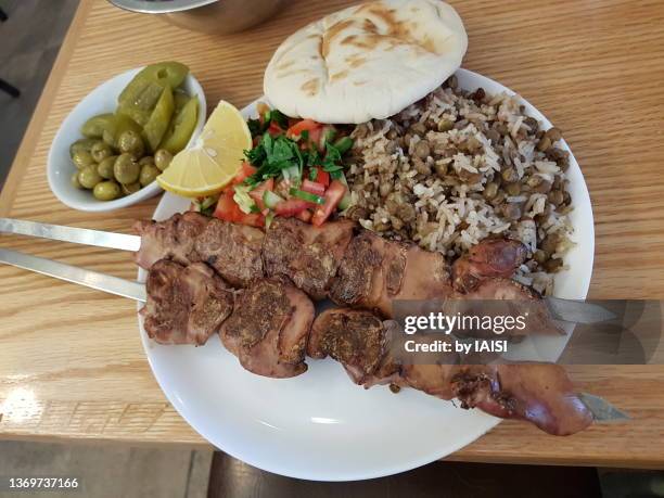 kosher food, basari, chicken liver skewers with rice and lentils (madjadra), and tomato cucumber salad, pita and olives, mediterranean food - kosher stock pictures, royalty-free photos & images