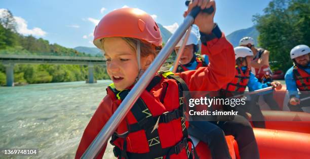 rrafters paddling their raft in the river - white water rafting stock pictures, royalty-free photos & images