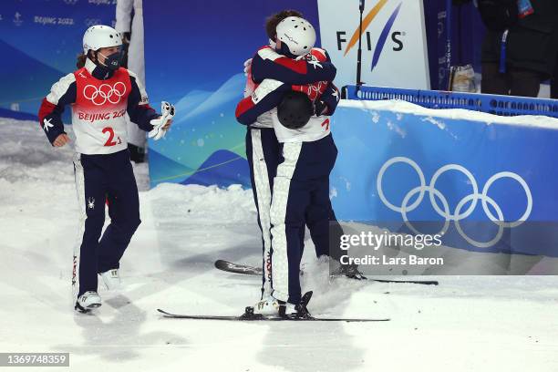 Christopher Lillis , Justin Schoenefeld and Ashley Caldwell of Team United States react during the Freestyle Skiing Mixed Team Aerials on Day 6 of...