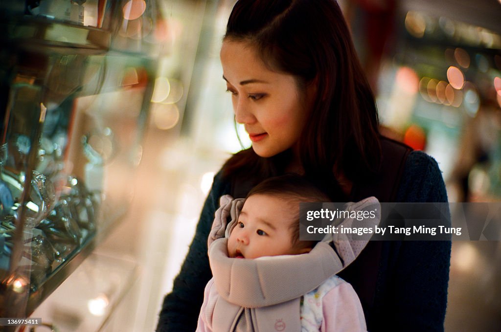 Mom and baby at window shopping